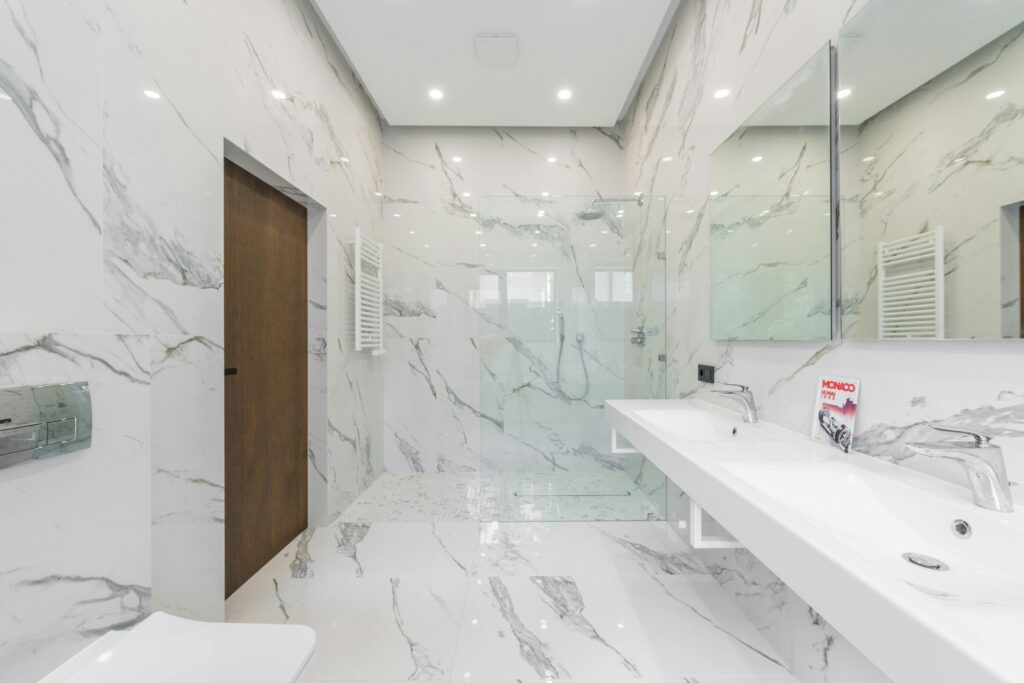 Elegant white marble bathroom with modern fixtures and minimalist design elements.